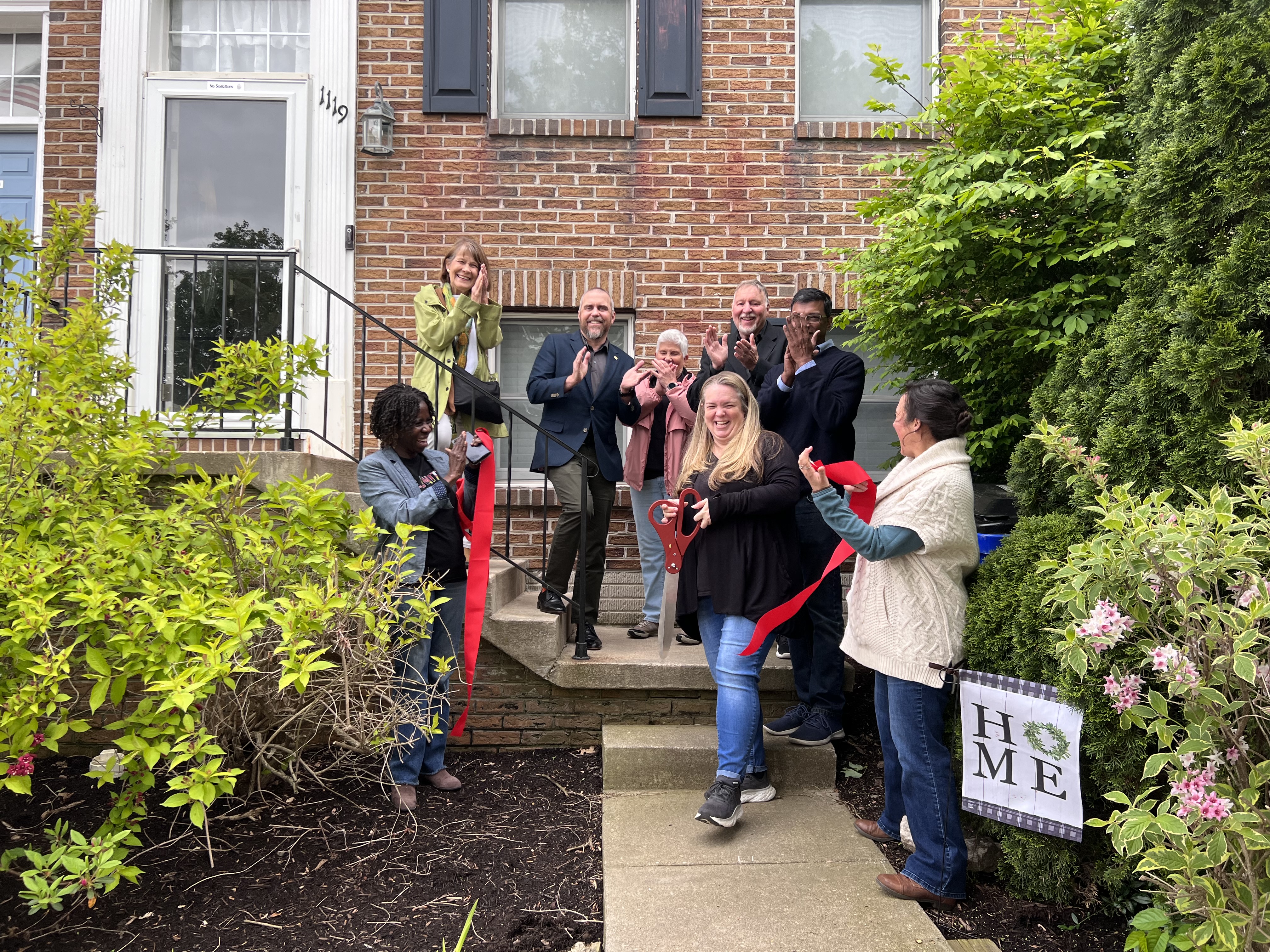 United Way Board and Staff Clapping at Ribbon Cutting for Laura Harris at her new home